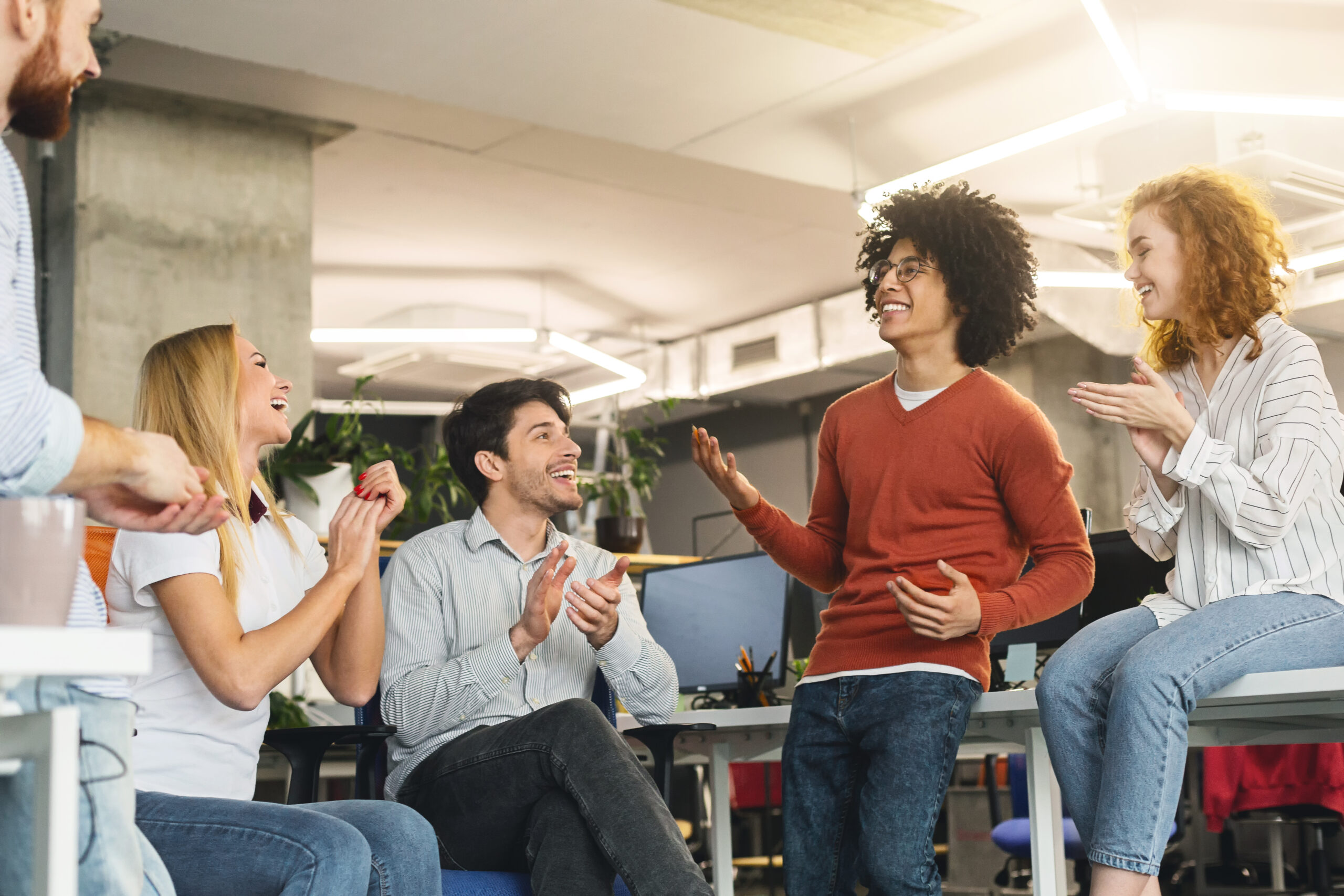 adobestock_261981547-scaled-1 Employee receiving recognition from the larger team