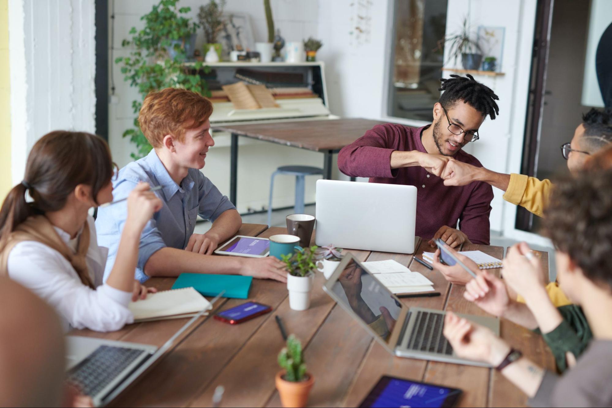 Employees collaborating at the meeting table